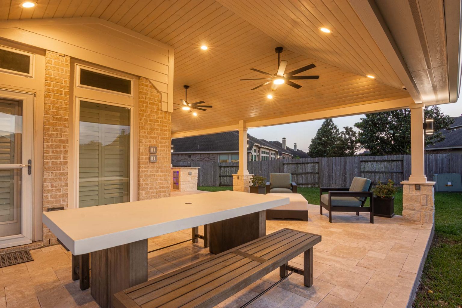 L Shaped Hip Style Patio Cover with Travertine Floor | HHI Patio Covers
